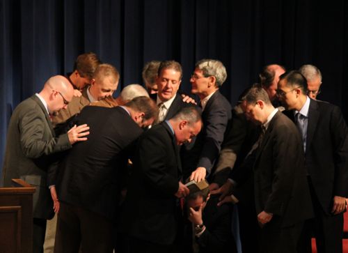 Brandon Crowe being prayed over by teaching and ruling elders